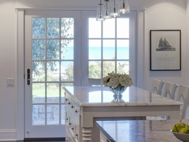 Elegant coastal kitchen and dining area with water views